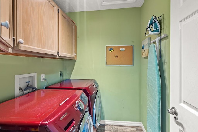 laundry area featuring cabinets and washer and clothes dryer