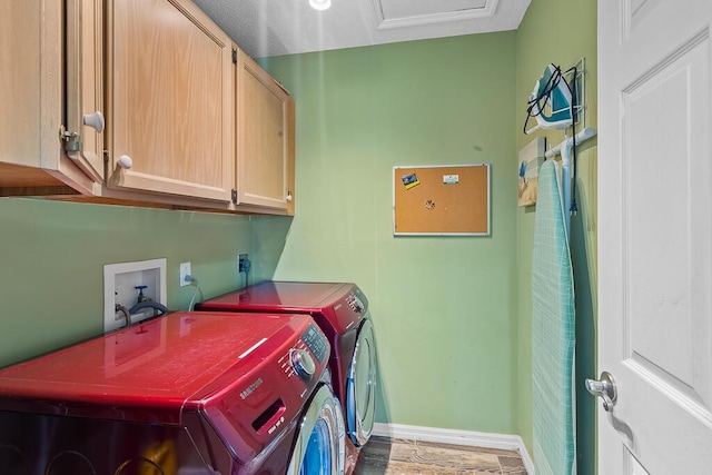 laundry area with cabinets and washer and clothes dryer