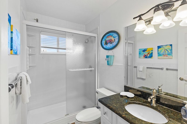 bathroom with toilet, an enclosed shower, a chandelier, tile walls, and vanity