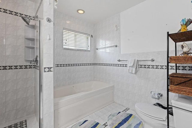 bathroom with tile patterned flooring, independent shower and bath, tile walls, and toilet