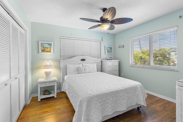 bedroom featuring hardwood / wood-style flooring, ceiling fan, a textured ceiling, and a closet