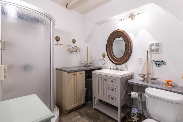 bathroom with vanity, toilet, and walk in shower