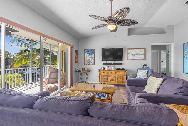 living room featuring lofted ceiling, hardwood / wood-style floors, a textured ceiling, and ceiling fan