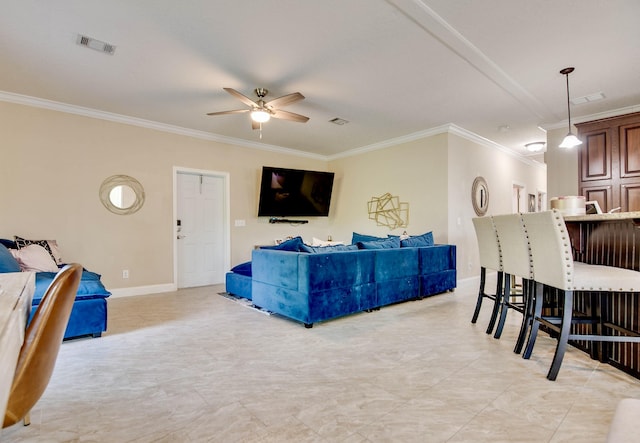 living room with crown molding and ceiling fan