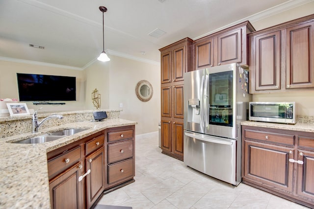 kitchen featuring sink, stainless steel appliances, ornamental molding, light stone countertops, and decorative light fixtures