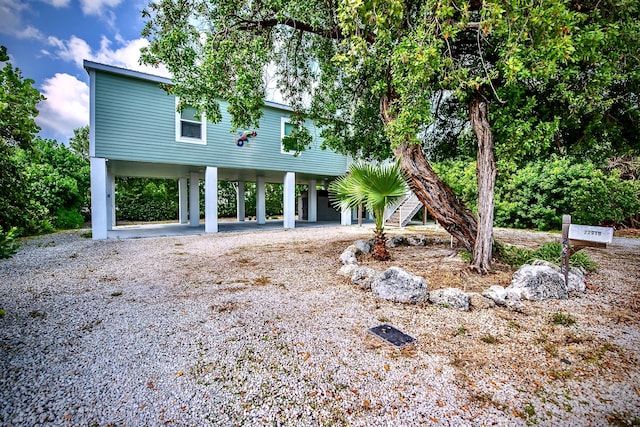 rear view of house featuring a carport