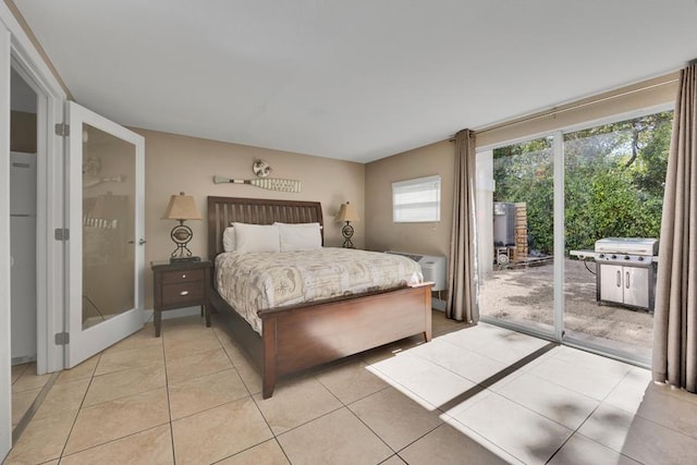 tiled bedroom with a wall mounted air conditioner and access to outside