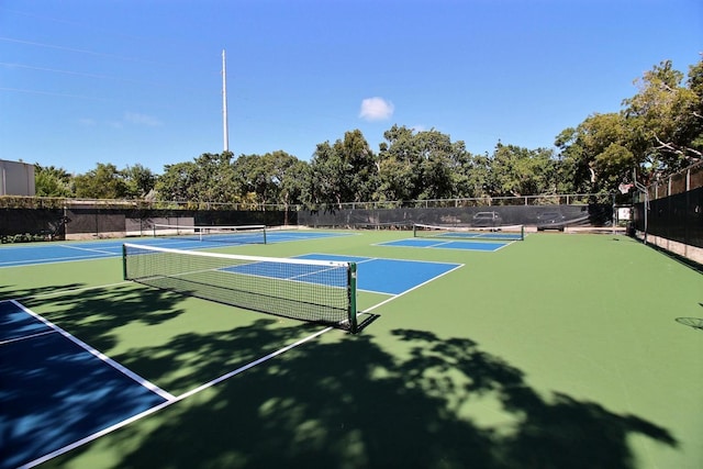 view of tennis court featuring basketball hoop