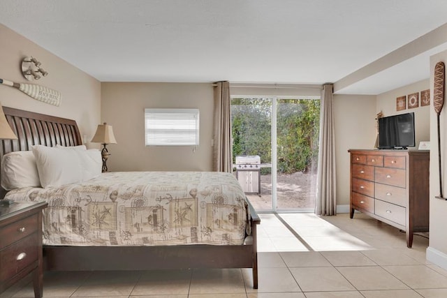 bedroom featuring access to exterior and light tile patterned floors