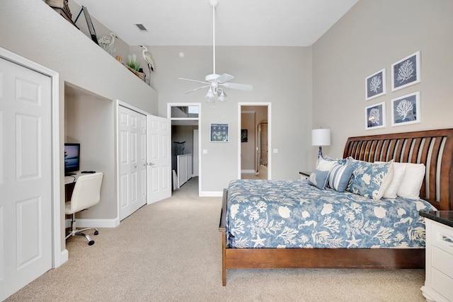 carpeted bedroom featuring a high ceiling and ceiling fan