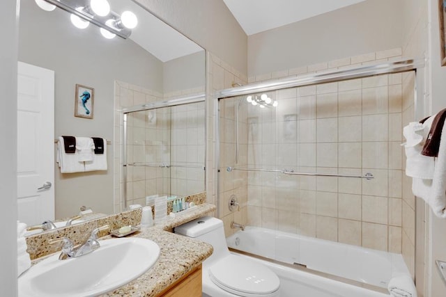 full bathroom featuring vanity, bath / shower combo with glass door, and toilet