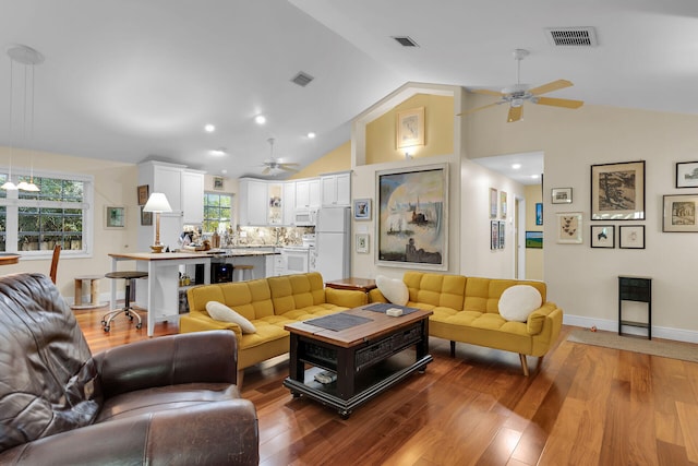 living room featuring hardwood / wood-style floors, high vaulted ceiling, and ceiling fan