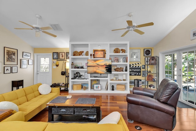 living room featuring wood-type flooring, vaulted ceiling, and a healthy amount of sunlight