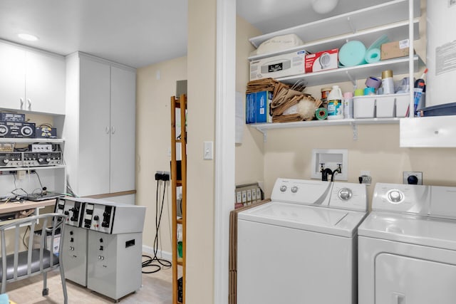 washroom with cabinets and independent washer and dryer