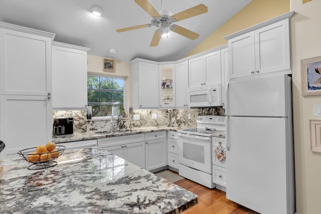 kitchen with white cabinetry, white appliances, light stone countertops, and sink