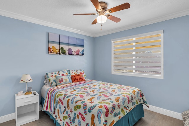 bedroom with ceiling fan, crown molding, wood-type flooring, and a textured ceiling