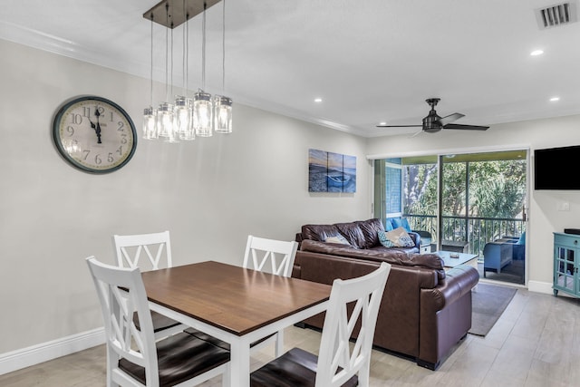 dining space with crown molding, light hardwood / wood-style floors, and ceiling fan