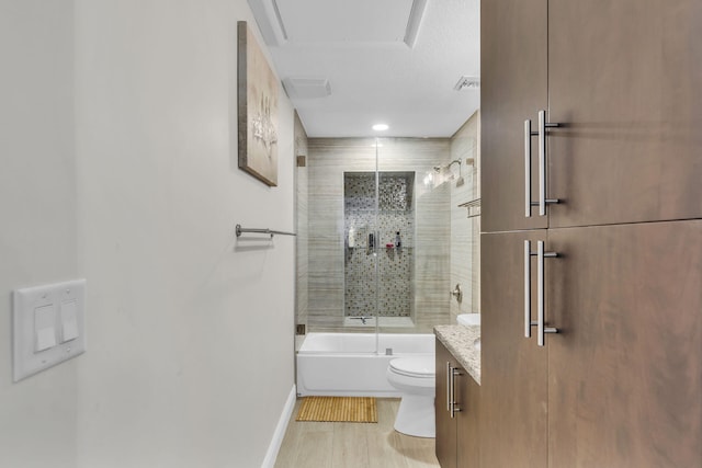 full bathroom with toilet, vanity, and bath / shower combo with glass door