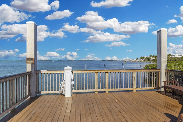 wooden terrace featuring a water view