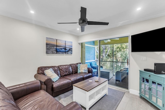 living room featuring crown molding and ceiling fan