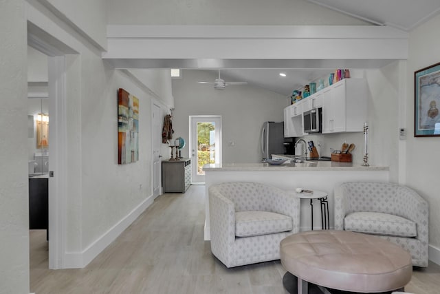 interior space with a peninsula, white cabinetry, appliances with stainless steel finishes, and light countertops