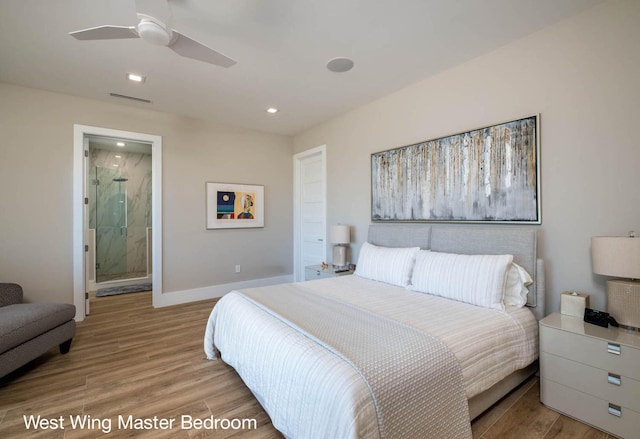 bedroom featuring ceiling fan, ensuite bath, and light hardwood / wood-style flooring