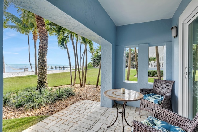 exterior space featuring a water view and a beach view