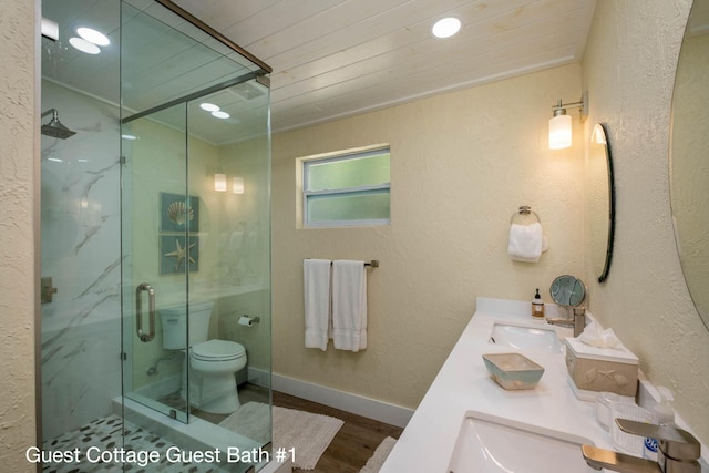 bathroom with walk in shower, vanity, toilet, and hardwood / wood-style floors