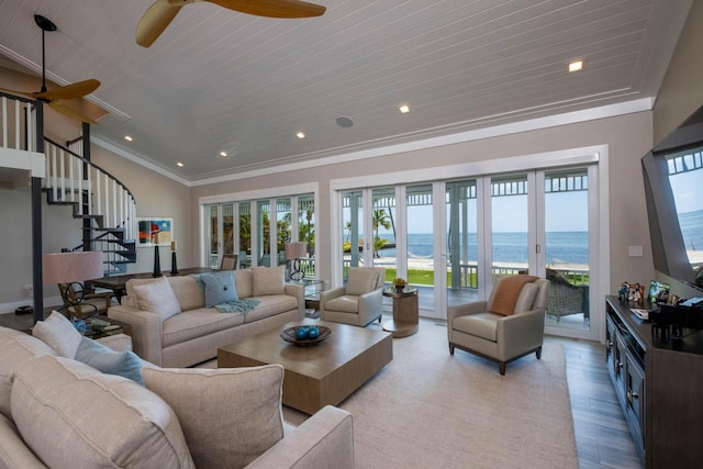 living room with ornamental molding, ceiling fan, light wood-type flooring, and french doors