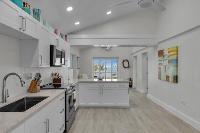 kitchen featuring ceiling fan, appliances with stainless steel finishes, a sink, and white cabinets