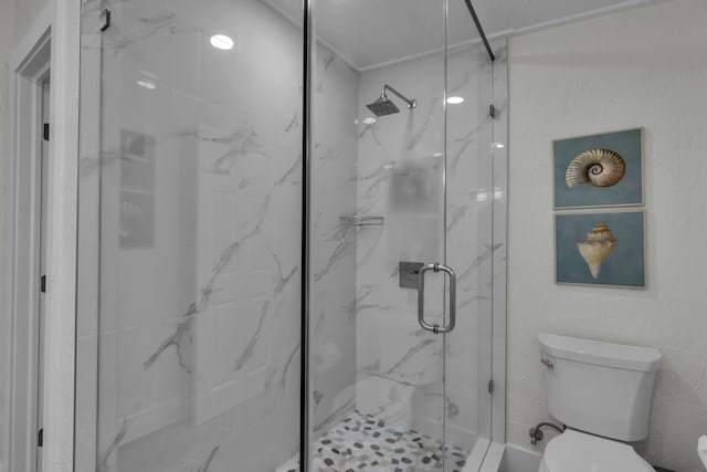 bathroom with a marble finish shower and toilet