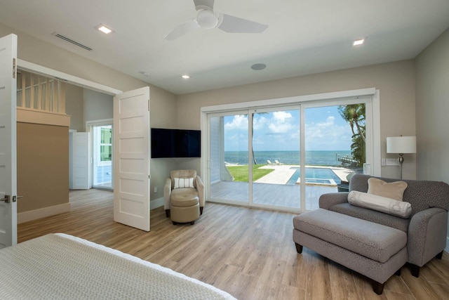 bedroom featuring access to exterior, visible vents, light wood-style flooring, ceiling fan, and baseboards