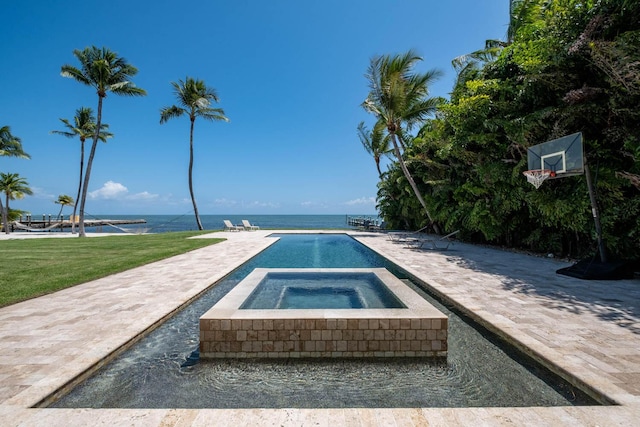 view of pool featuring a water view, a yard, and an in ground hot tub