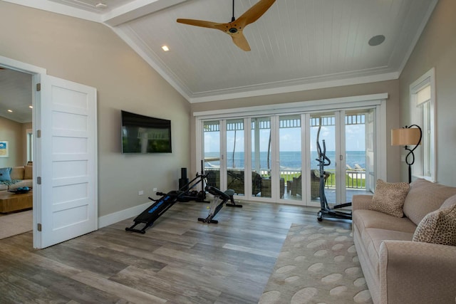 exercise room featuring crown molding, a ceiling fan, wood finished floors, high vaulted ceiling, and baseboards