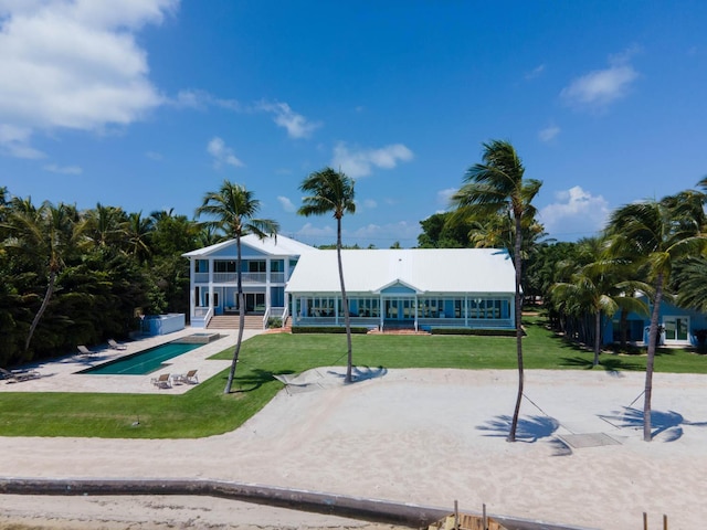 view of home's community with a swimming pool and a lawn