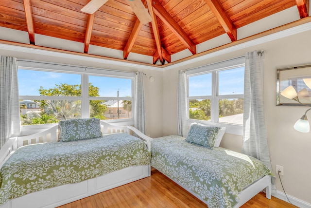 bedroom with wooden ceiling, multiple windows, and wood finished floors