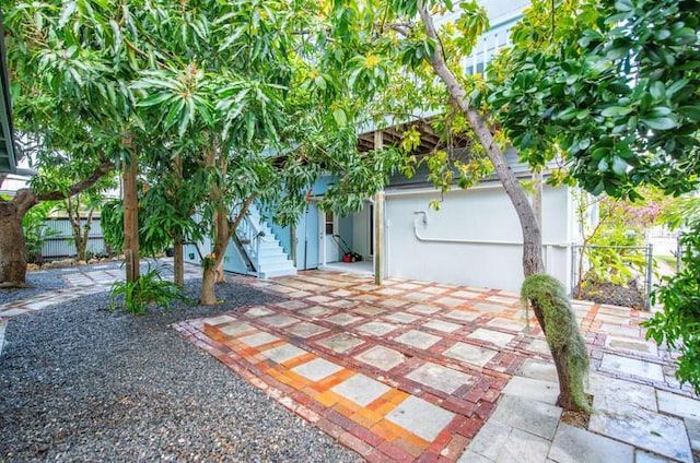 view of front of house with a patio and fence