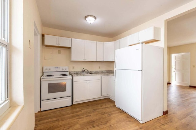 kitchen with sink, white appliances, light hardwood / wood-style floors, and white cabinets