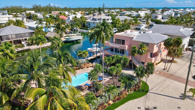 drone / aerial view with a water view and a residential view