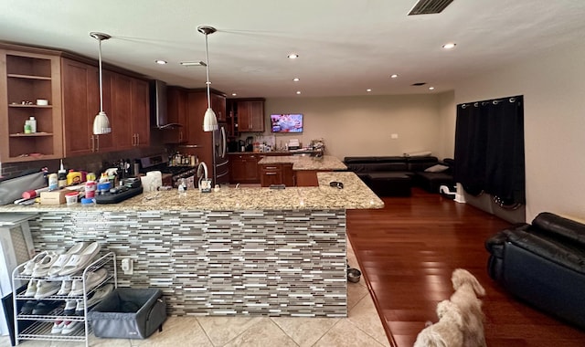 397 Balido St, Key West, FL 33040 - kitchen with open floor plan, a peninsula, appliances with stainless steel finishes, wall chimney exhaust hood, and recessed lighting