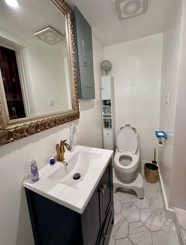 397 Balido St, Key West, FL 33040 - bathroom with electric panel, vanity, toilet, and marble look tile flooring
