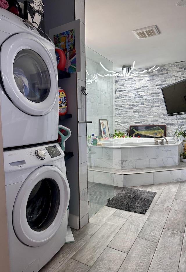 397 Balido St, Key West, FL 33040 - clothes washing area with stacked washer / dryer and wood finish floors