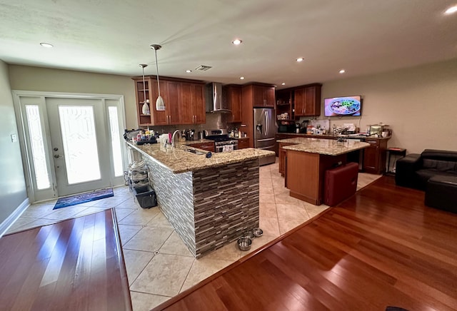 397 Balido St, Key West, FL 33040 - kitchen with appliances with stainless steel finishes, a sink, wall chimney exhaust hood, light stone countertops, and recessed lighting