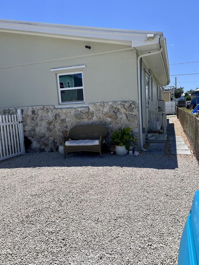 397 Balido St, Key West, FL 33040 - view of side of property with stone siding and fence