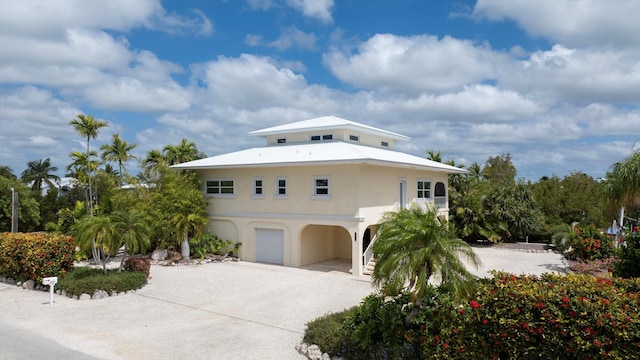 view of front of property featuring a carport and a garage