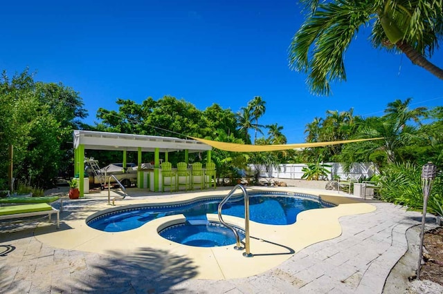 view of swimming pool with a patio area and an in ground hot tub