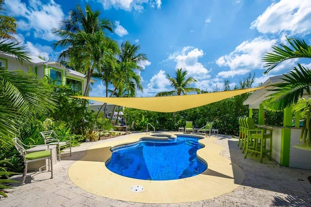 view of swimming pool featuring an in ground hot tub, a bar, and a patio