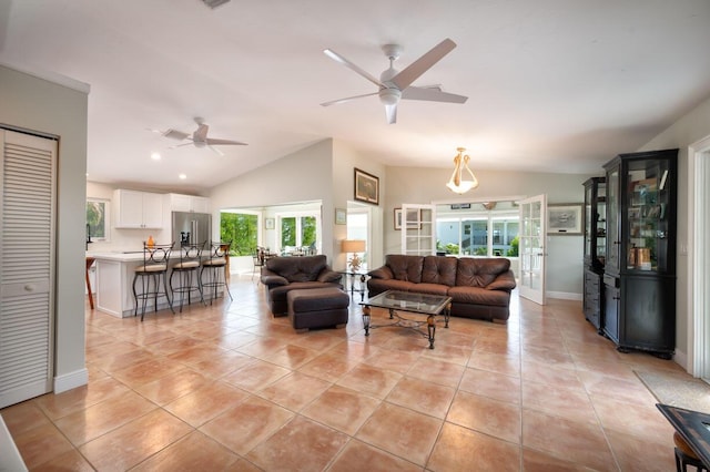 living room featuring ceiling fan, lofted ceiling, and light tile patterned floors