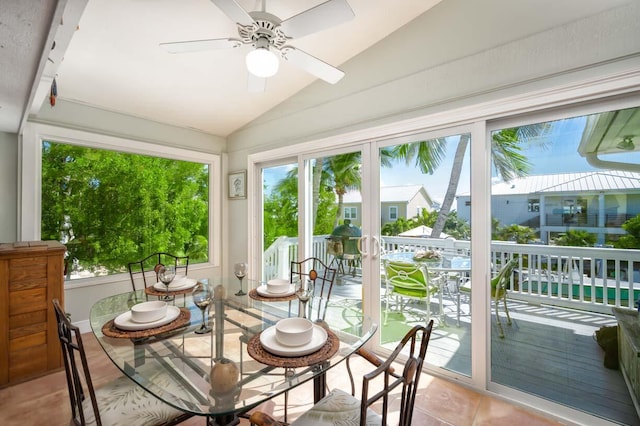 sunroom / solarium with vaulted ceiling, a wealth of natural light, and ceiling fan