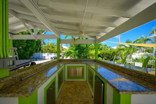 view of patio featuring an outdoor kitchen and a wet bar